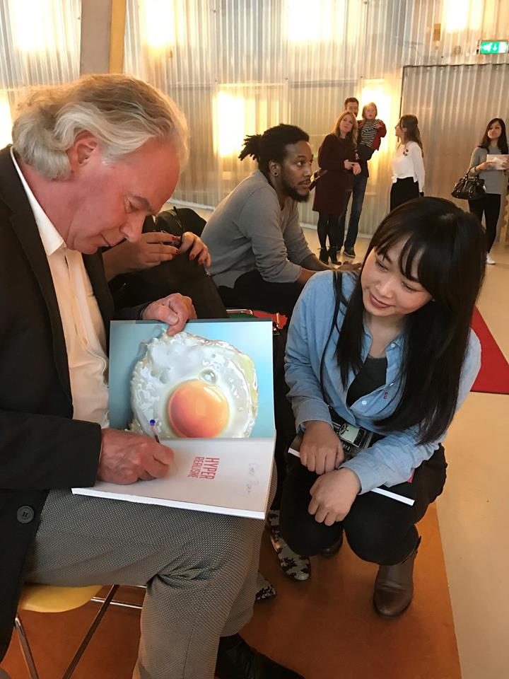 signing the catalogue for a fan